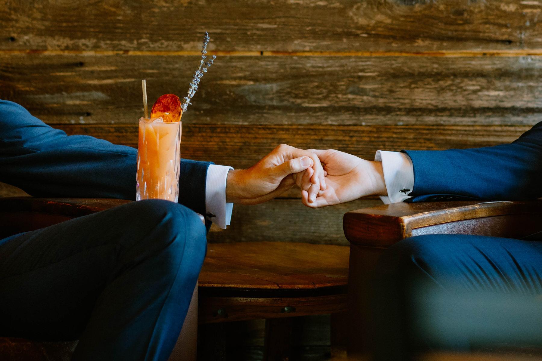 Two men holding hands