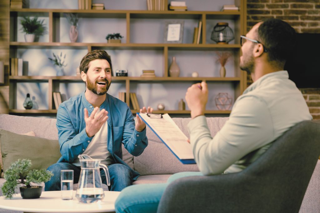 Therapist and client in a counseling session discussing emotions in an LGBTQ+ affirming therapy setting in Dallas