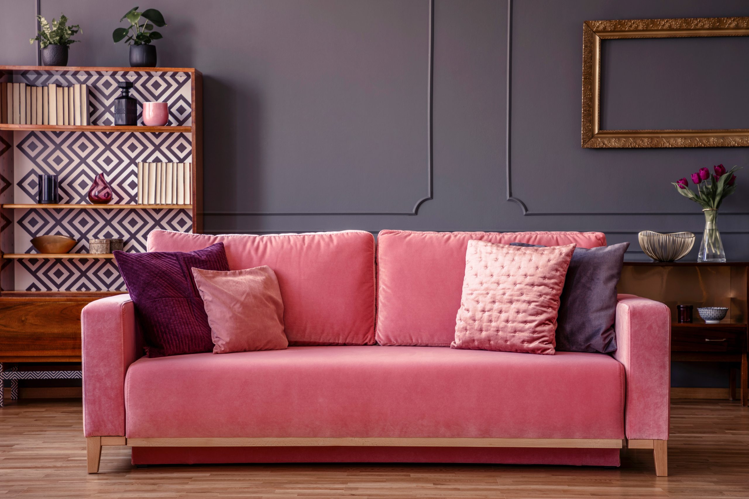 Warm and inviting therapy-inspired interior featuring a pink sofa, textured pillows, soft lighting, and thoughtfully curated décor, creating a comfortable environment for reflection, conversation, and healing.