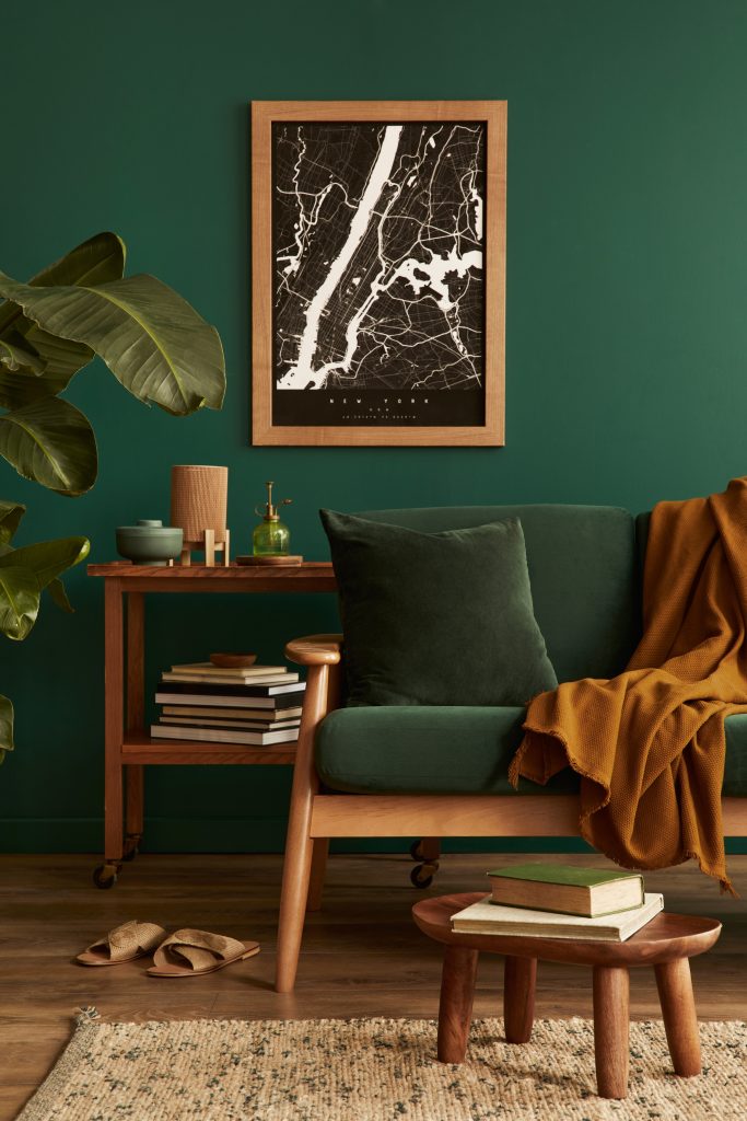 Comfortable therapy-inspired room with a green armchair, books, plants, and warm decor, representing a safe space for reflection and growth.
