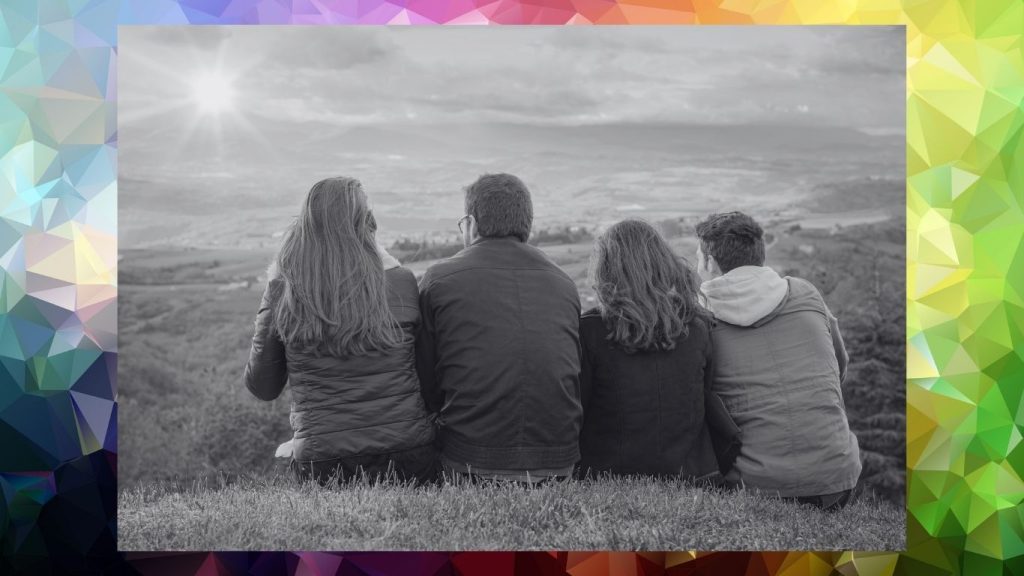 Family of four sitting together overlooking a landscape, symbolizing connection, support, and the complexity of modern relationships.