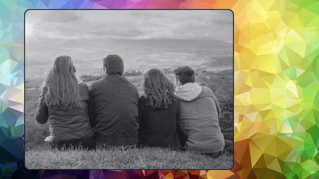 Family of four sitting together overlooking a landscape, symbolizing connection, support, and the complexity of modern relationships.