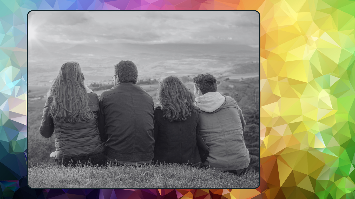 Four people sitting together overlooking a landscape, representing connection and support in ethical non-monogamous relationships.