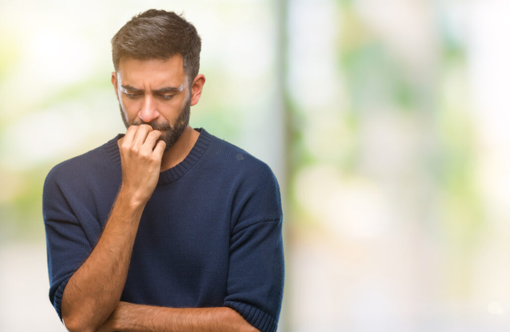 Man appearing anxious while reflecting on the emotional impact of living with HIV