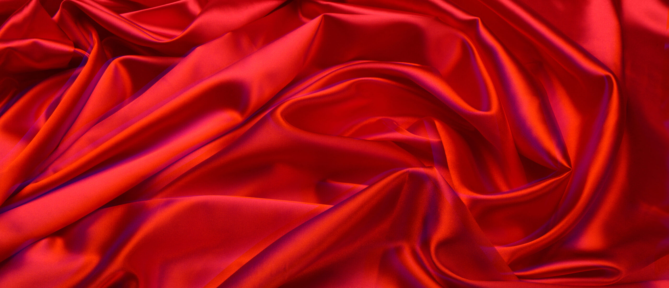 Red satin fabric representing intimacy, sexuality, and connection while living with HIV